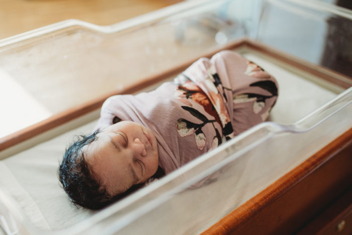 Newborn in hospital bassinet