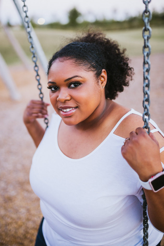 girl in white shirt sitting on swing