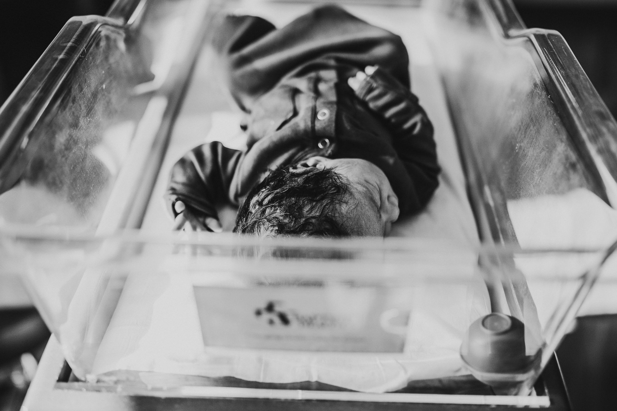 Newborn baby in hospital bassinet