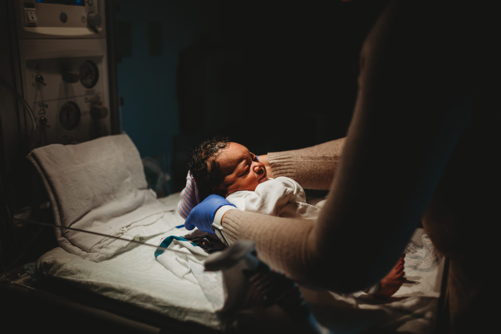 Nurse putting hat on Newborn